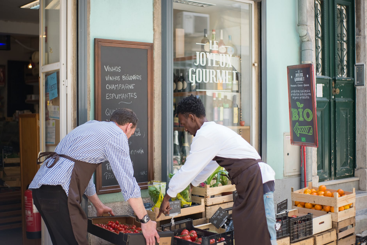 Men fixing the products in the vegetable stand