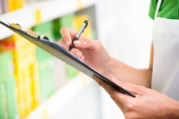store worker using a clipboard