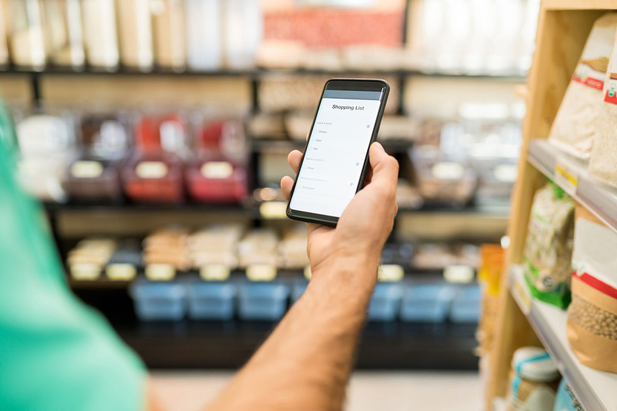 Man using mobile phone in grocery store