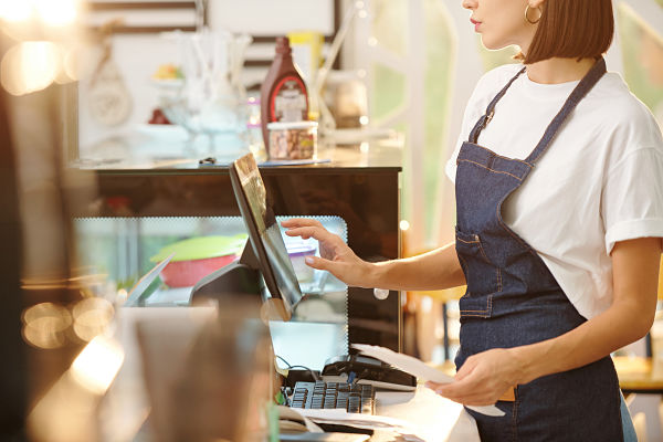 woman using monitor at a cafe